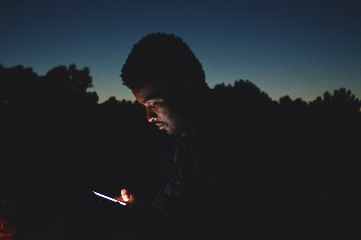 man with phone at night
